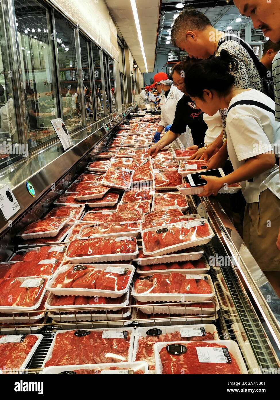 Chinese customers shop for beef and other meat products at the Costco store in Shanghai, China, 28 August 2019. Stock Photo