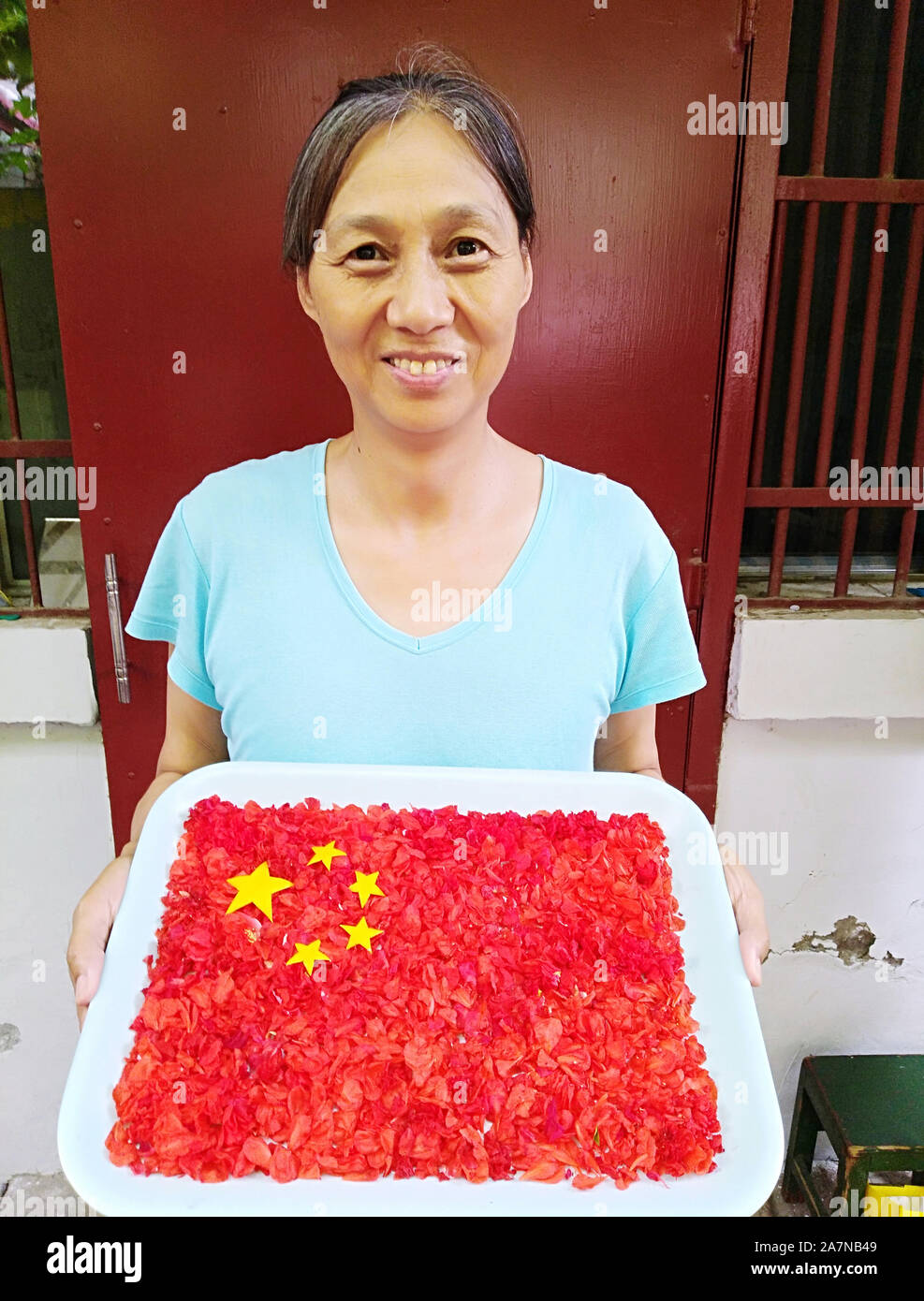 Photo of the Chinese flag made from flowers in Kaifeng city, central China's Henan province, 29 August 2019. A 70-year-old couplle, Mr. and Mrs. Zhang Stock Photo