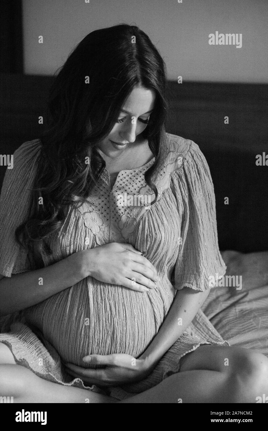 Pregnant Woman in bed black and white Stock Photo