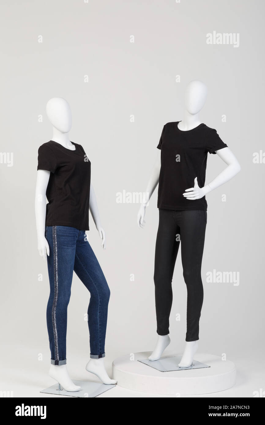 Two female mannequins dressed in fashionable clothes over white background. No brand names or copyright objects. Stock Photo