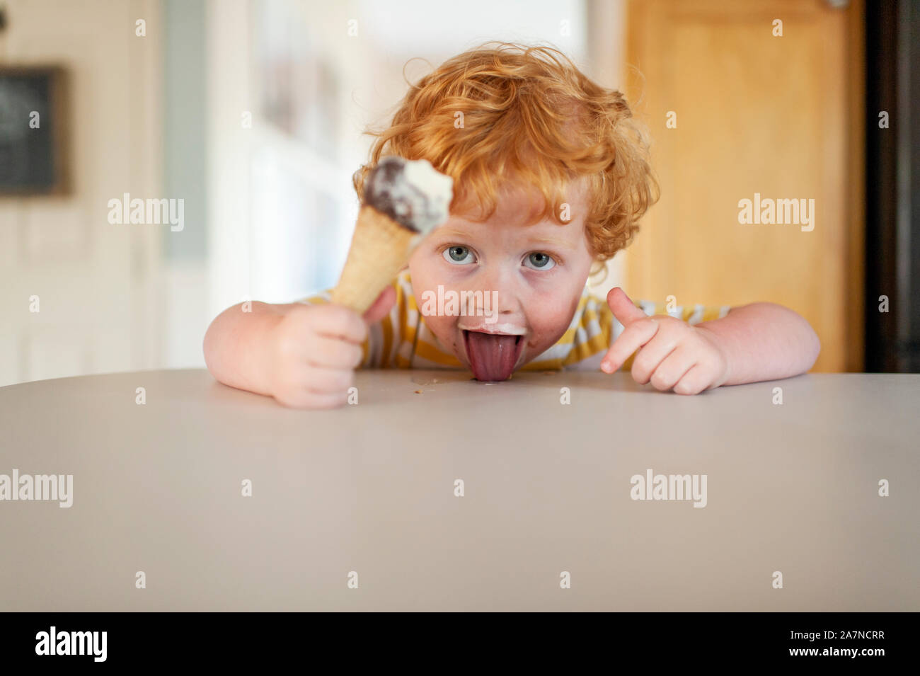 Boy licking ice cream cone hires stock photography and images Alamy