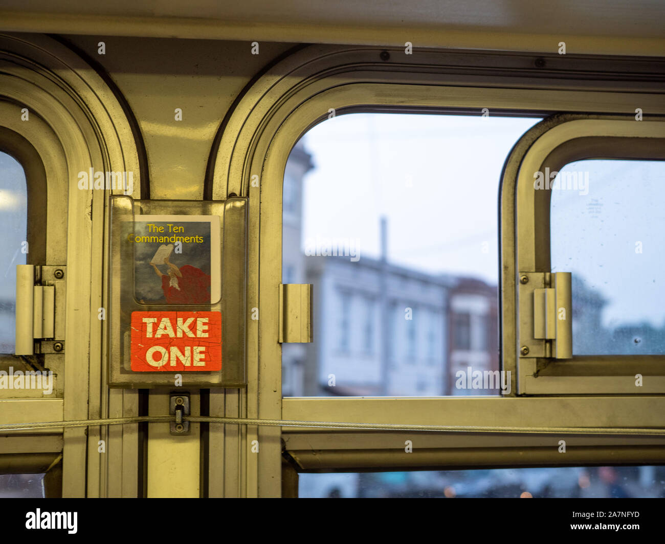 Bus with Ten Commandments religious pamphlet with take one sign handing near window Stock Photo