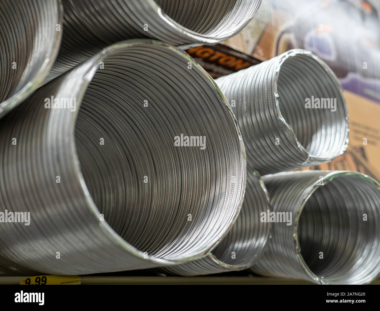 Aluminum duct sections piled high in store for purchase Stock Photo