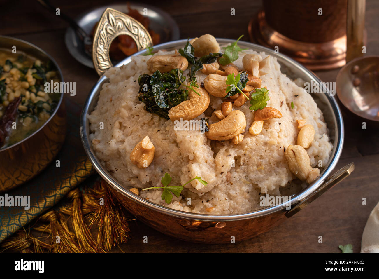 Pongal- South Indian rice and lentil porridge, spiced with black pepper, cumin, ginger, ghee and nuts Stock Photo