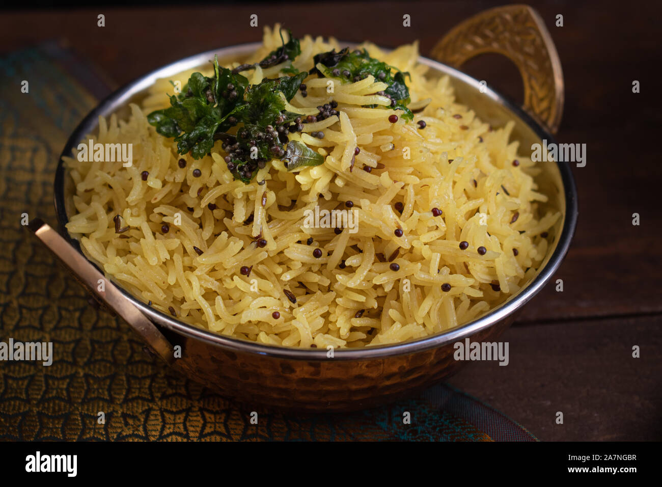 Indian lemon rice pilaf served in copper bowl Stock Photo