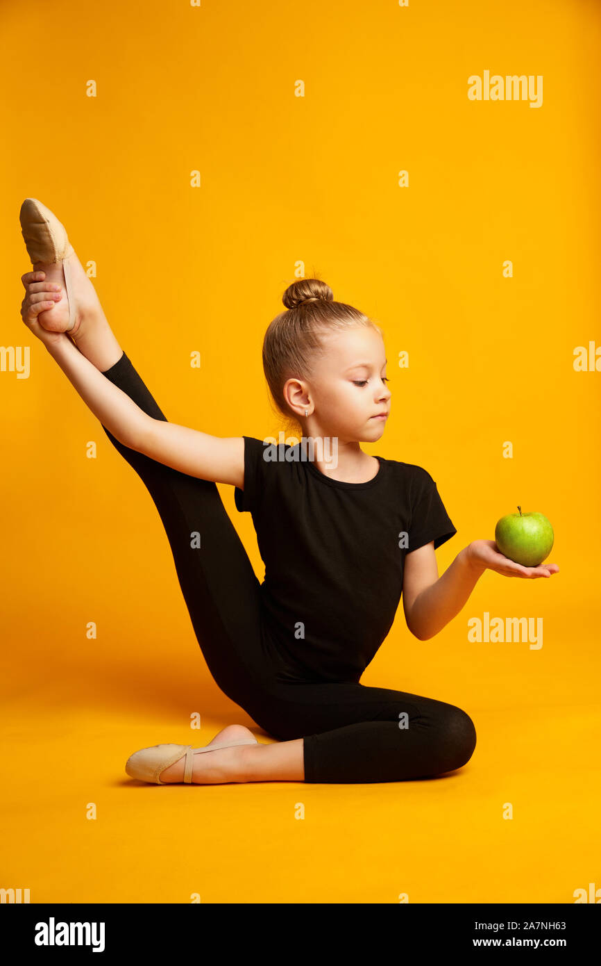 Little child enjoy vitamin diet after yoga training. Healthy nutrition for kids. Developing good health habits Stock Photo