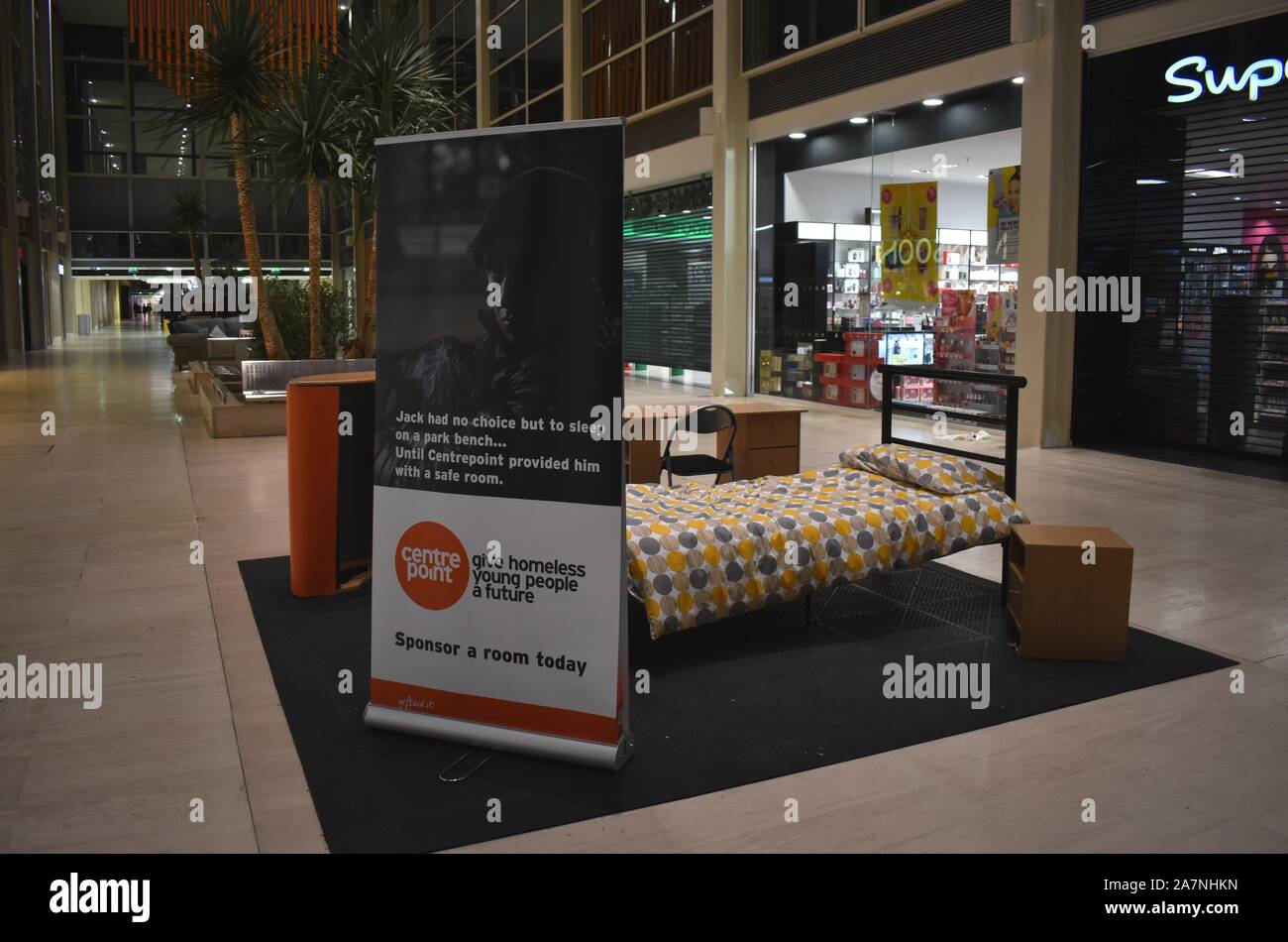A mock up of a bedroom in the shopping centre in Milton Keynes.  An advert for centrepoint charity, while the homeless sleep outside on the street. Stock Photo