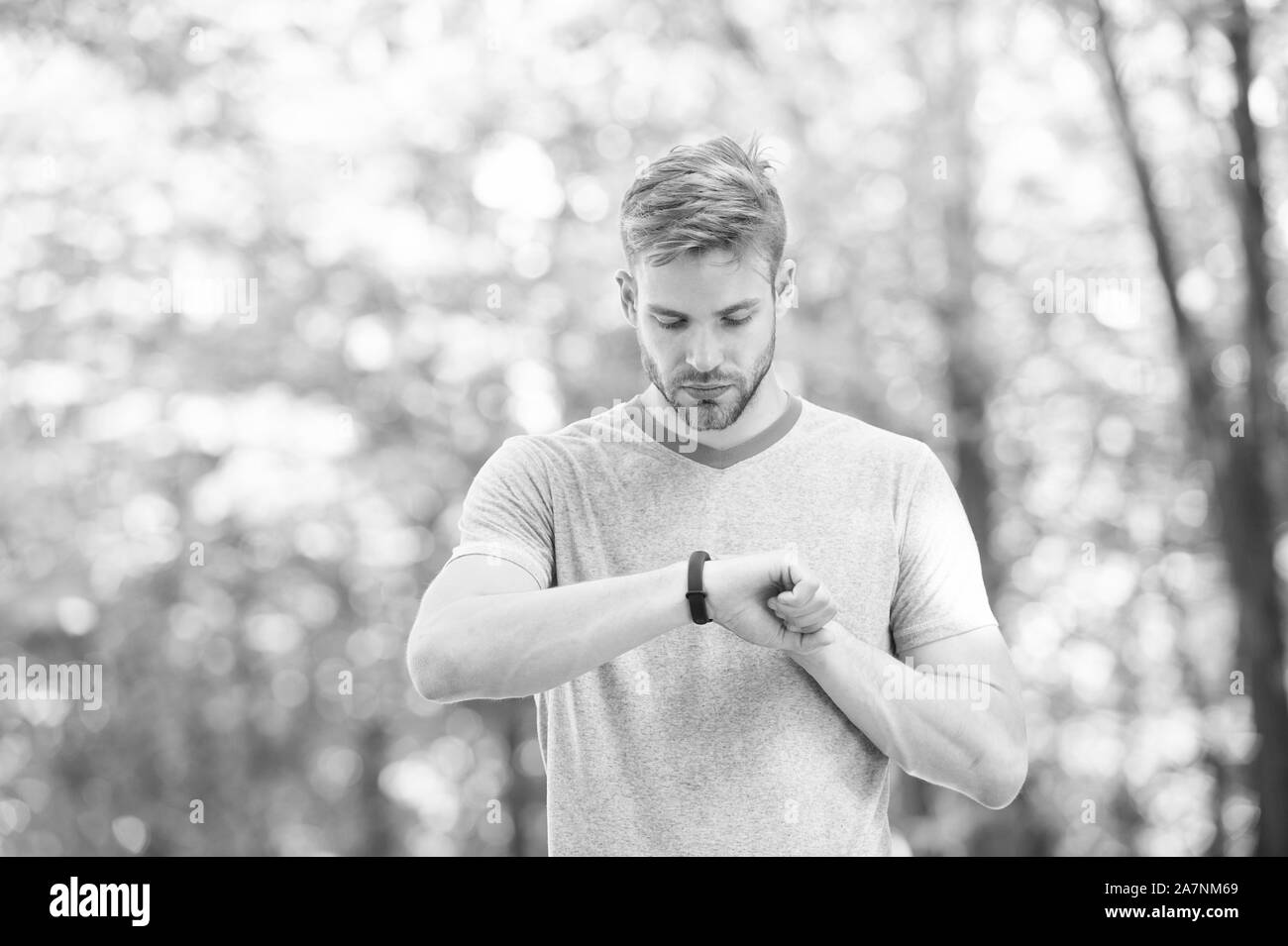 Wearable technology. Handsome athlete using smartwatch technology