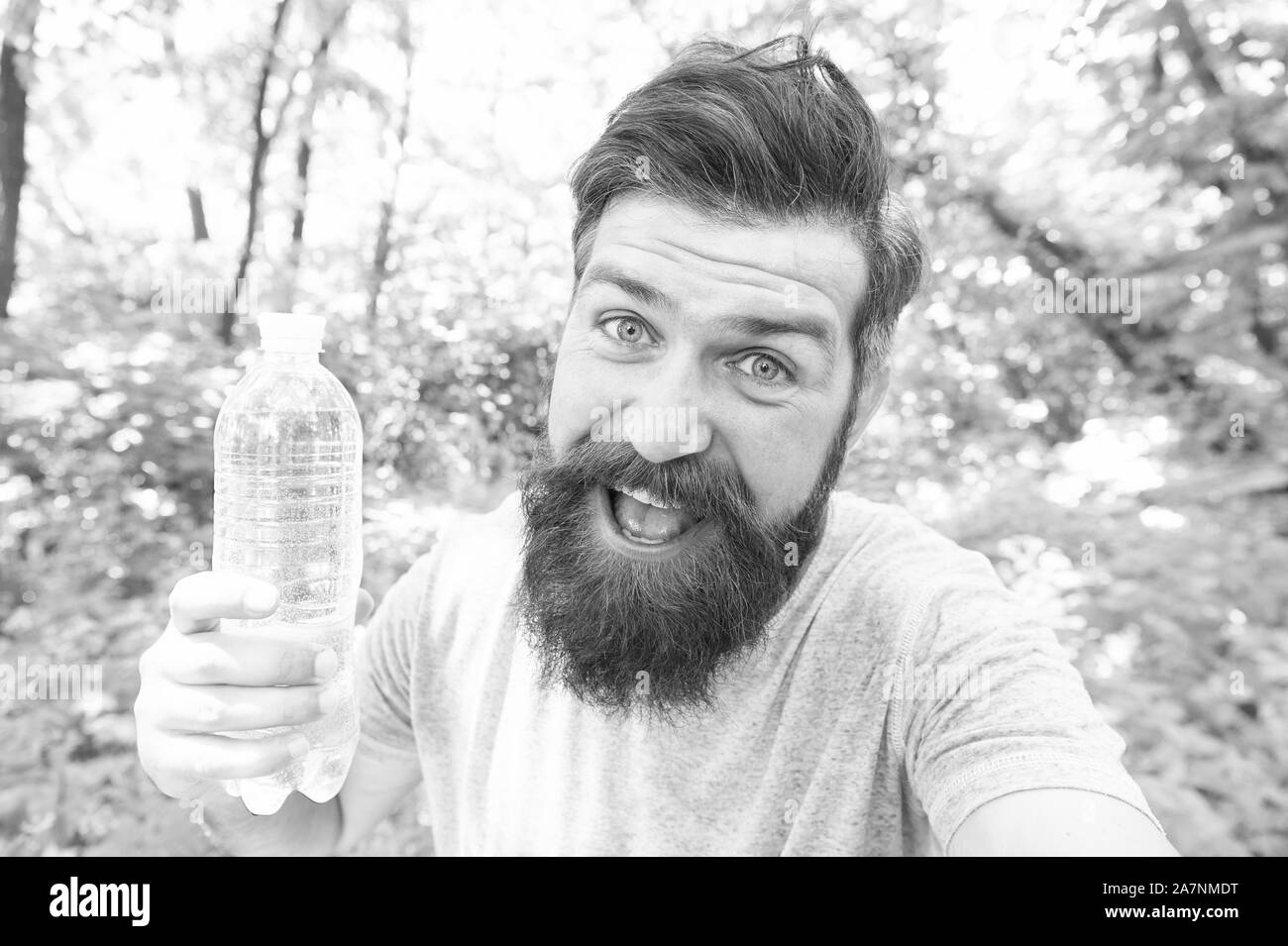 Thirst is everything. Thirsty man. Bearded man holding bottle of drinking water to quench his