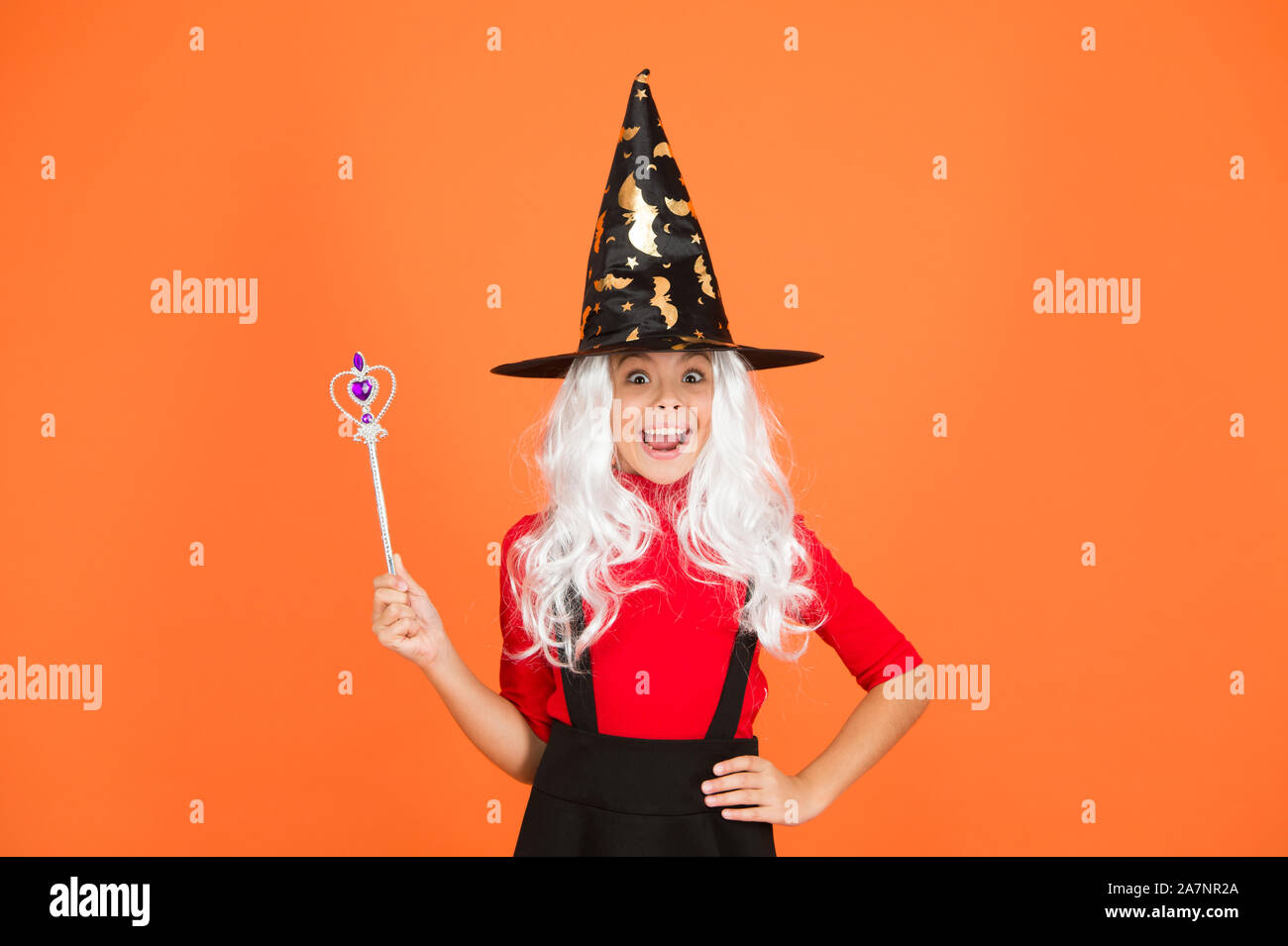 Add magic to your life. witch do magic. small child witch hat. trick or treat. supernatural charmer. kid enchantress wave magic wand. happy halloween. believe in magic. small girl halloween party. Stock Photo