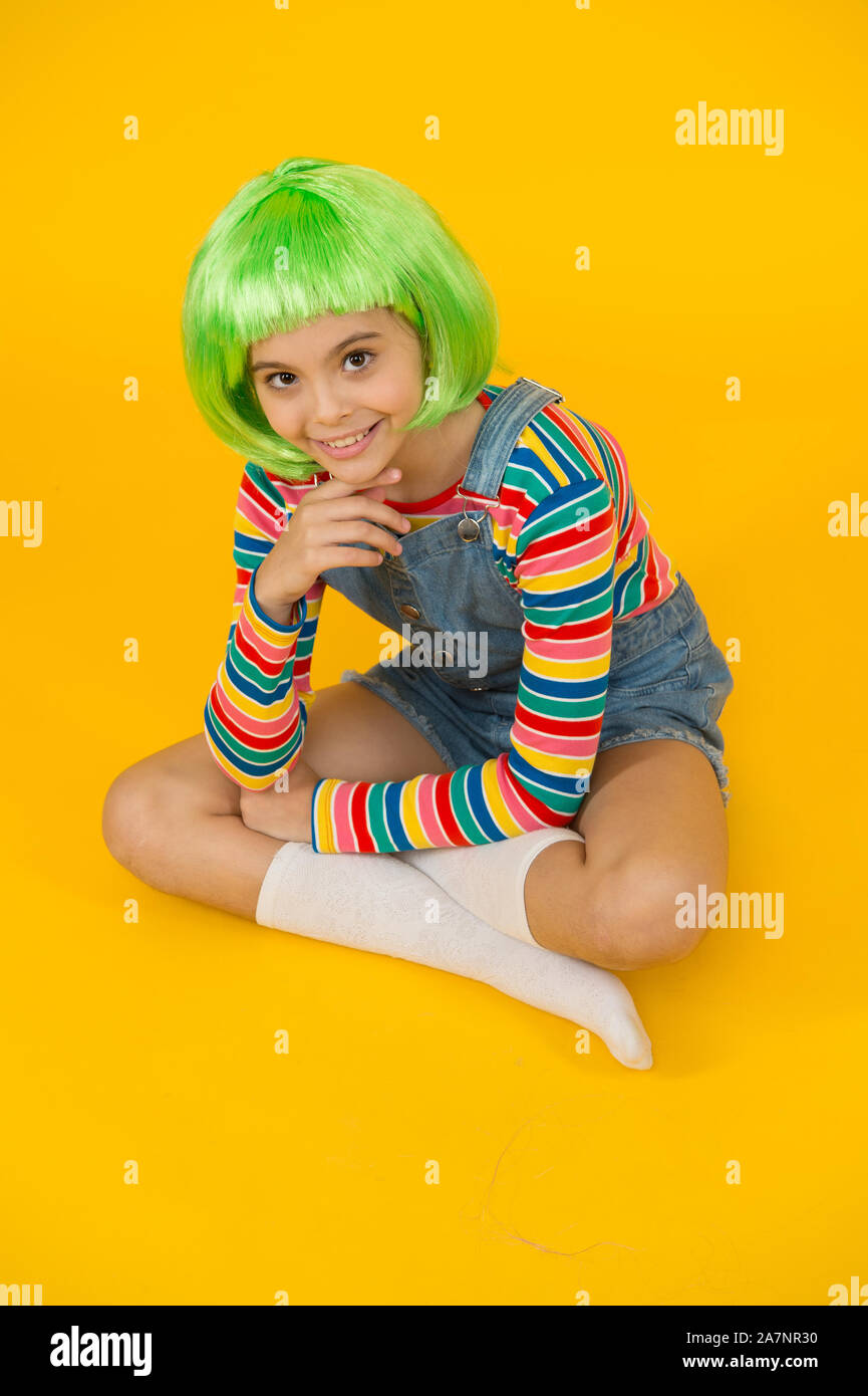 Create new look in salon. Happy girl with beauty look. Little child wear green hair wig in fancy style. Beauty and hair salon. Fashion salon. Salon or parlor. Color and style hair Create new look in salon. Happy girl with beauty look. Little child wear green hair wig in fancy style. Beauty and hair salon. Fashion salon. Salon or parlor. Color and style hair
