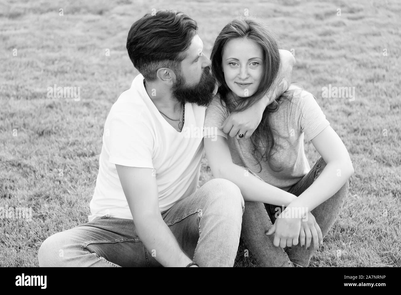 Couple spend time in nature. Playful girlfriend and boyfriend dating. Summer vacation. Lovely couple outdoors. Couple in love relaxing on green lawn. Simple happiness. Couple relations goals. Stock Photo