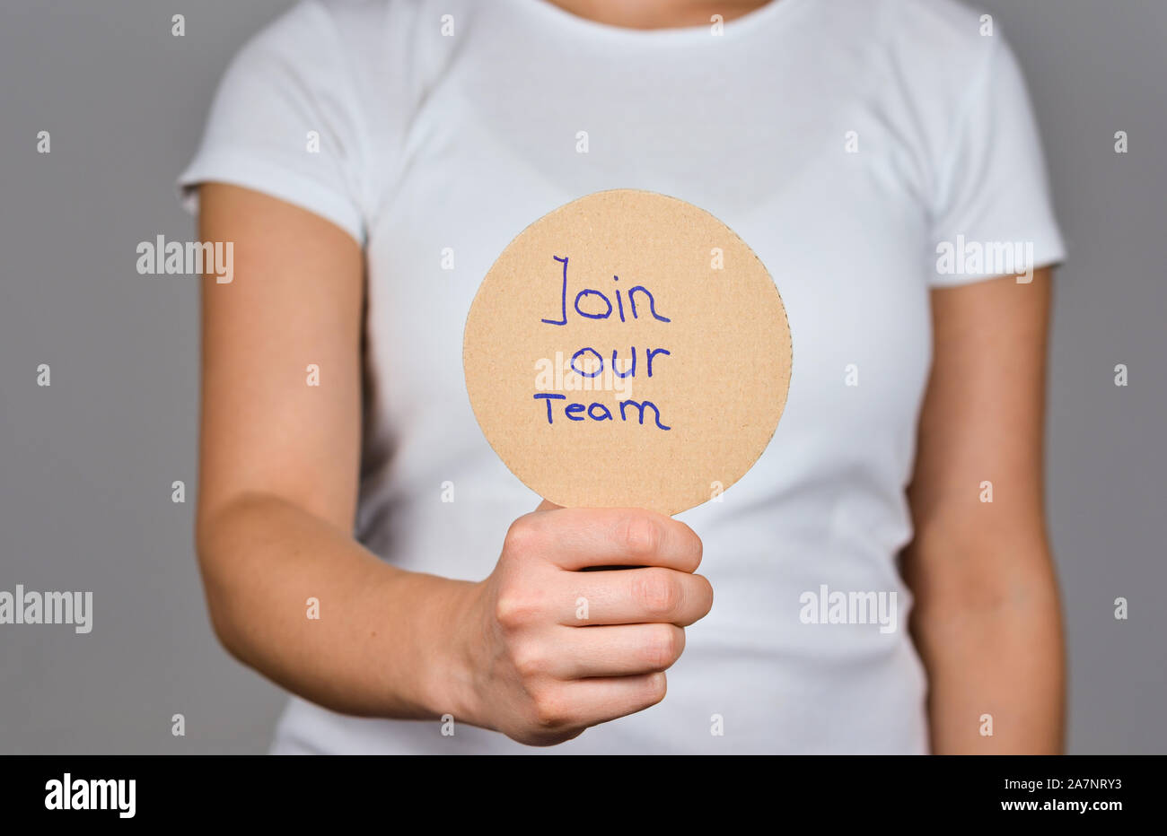 Join our Team sentence handwritten on a round cardboard paper in a women hand Stock Photo Alamy
