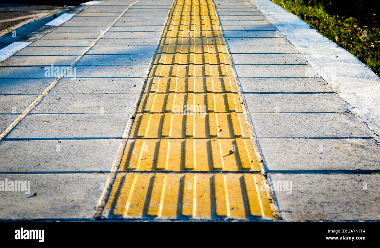 Yellow sidewalk markers for the blind pedestrians Stock Photo Alamy