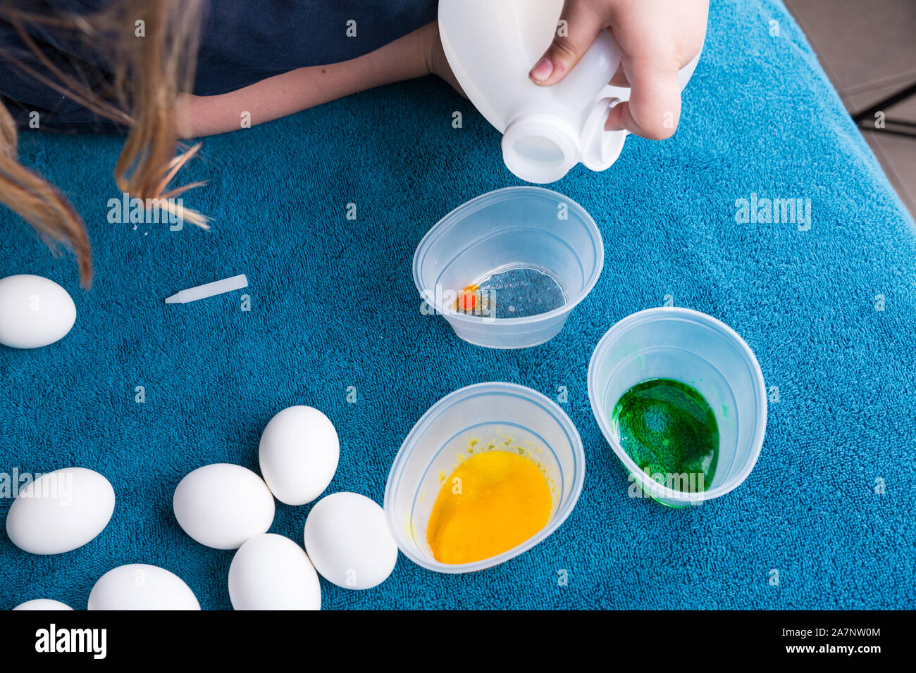 Pouring vinegar into tubs for easter egg dyeing Stock Photo Alamy