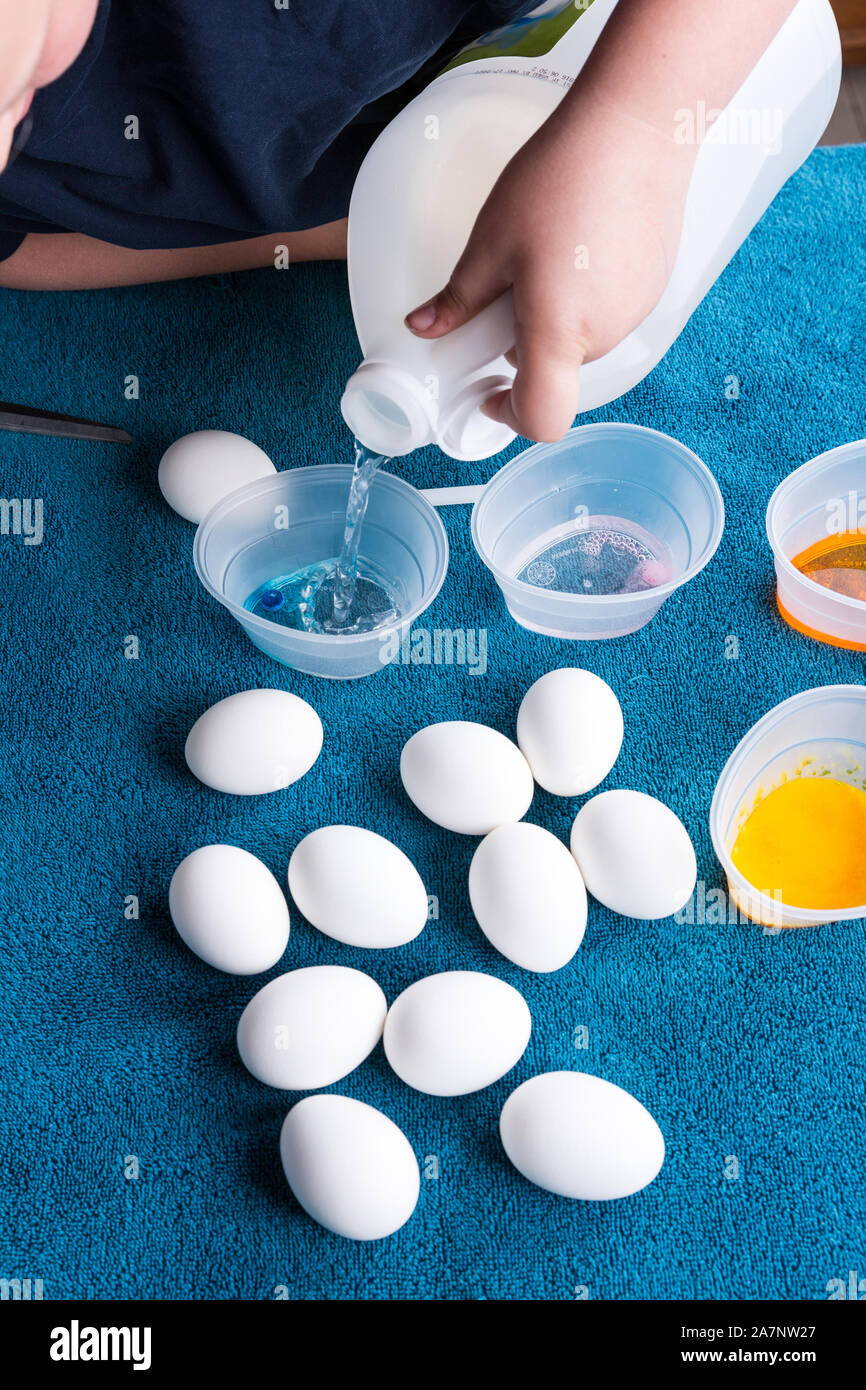 Pouring vinegar into tubs for easter egg dyeing Stock Photo Alamy