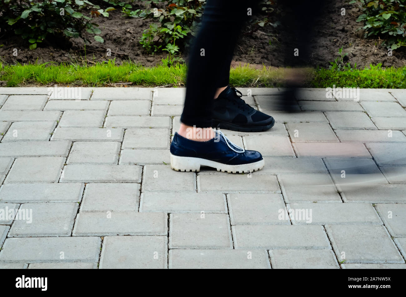 A hurried woman walking on the street - Motion Bluer effect Stock Photo