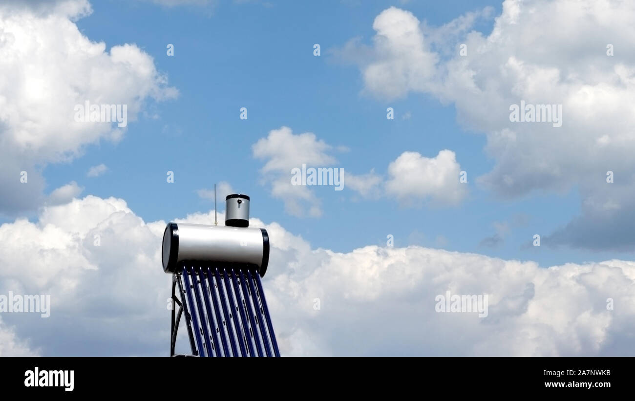 Solar water heating system agains blue sky . Evacuated tube collectors type- Vacuum collectors . Stock Photo