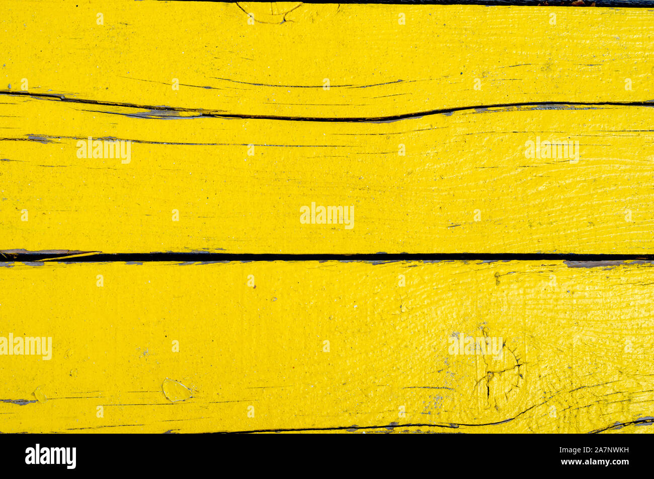 Full frame shot of rusty   yellow painted wooden timber  wall . Stock Photo