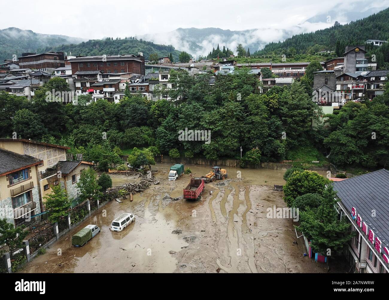 Roads, fields and residential buildings are covered with mud and submerged by floodwater after multiple mudslides triggered by heavy rainfall in Shuim Stock Photo