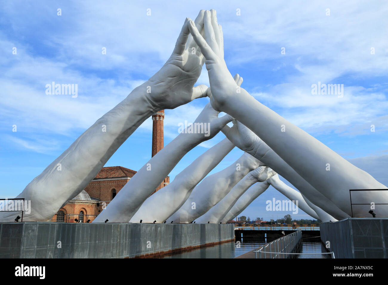 Art Biennale Venice 2019. Giant joined hands sculpture 'Building Bridges' by Lorenzo Quinn. Exhibition at Arsenale, Castello, Venice. Stock Photo