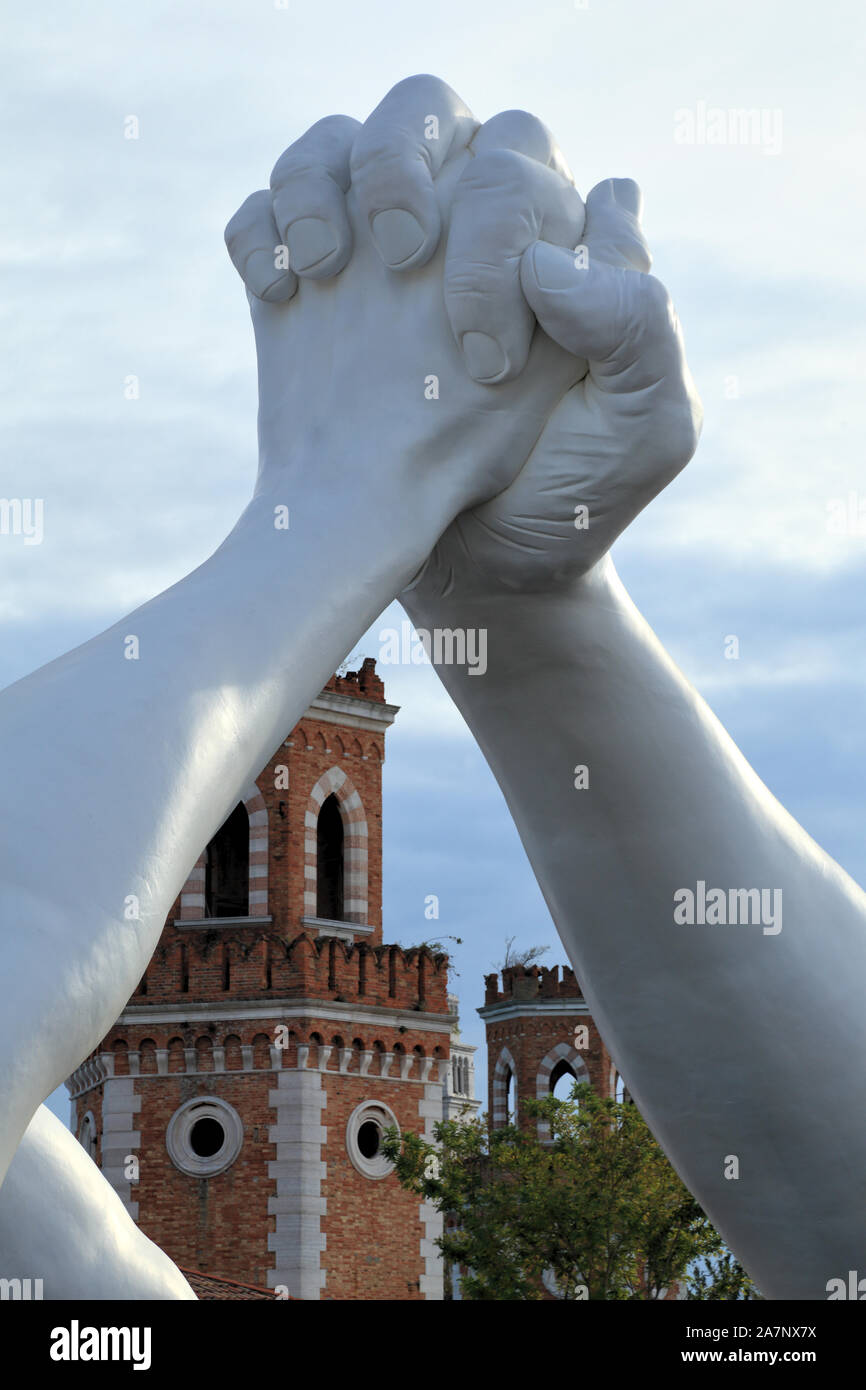 Art Biennale Venice 2019. Giant joined hands sculpture 'Building Bridges' by Lorenzo Quinn. Friendship. Exhibition at Arsenale, Castello, Venice. Stock Photo