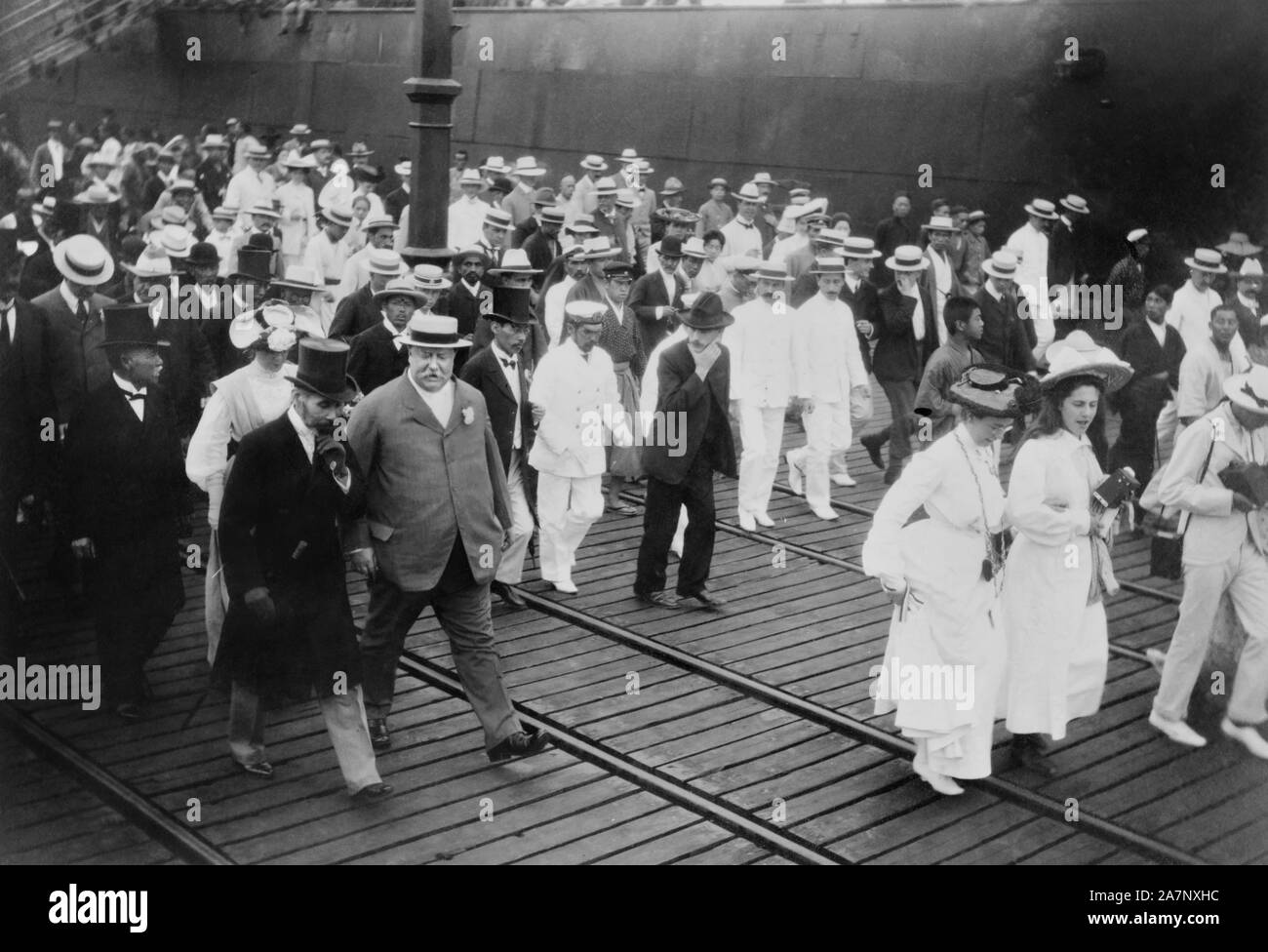 U.S. Secretary of War William Howard Taft with group of Dignitaries Leaving Dock at Yokohama, Japan, during Diplomatic Mission, Photograph by Burr McIntosh, July 1905 Stock Photo
