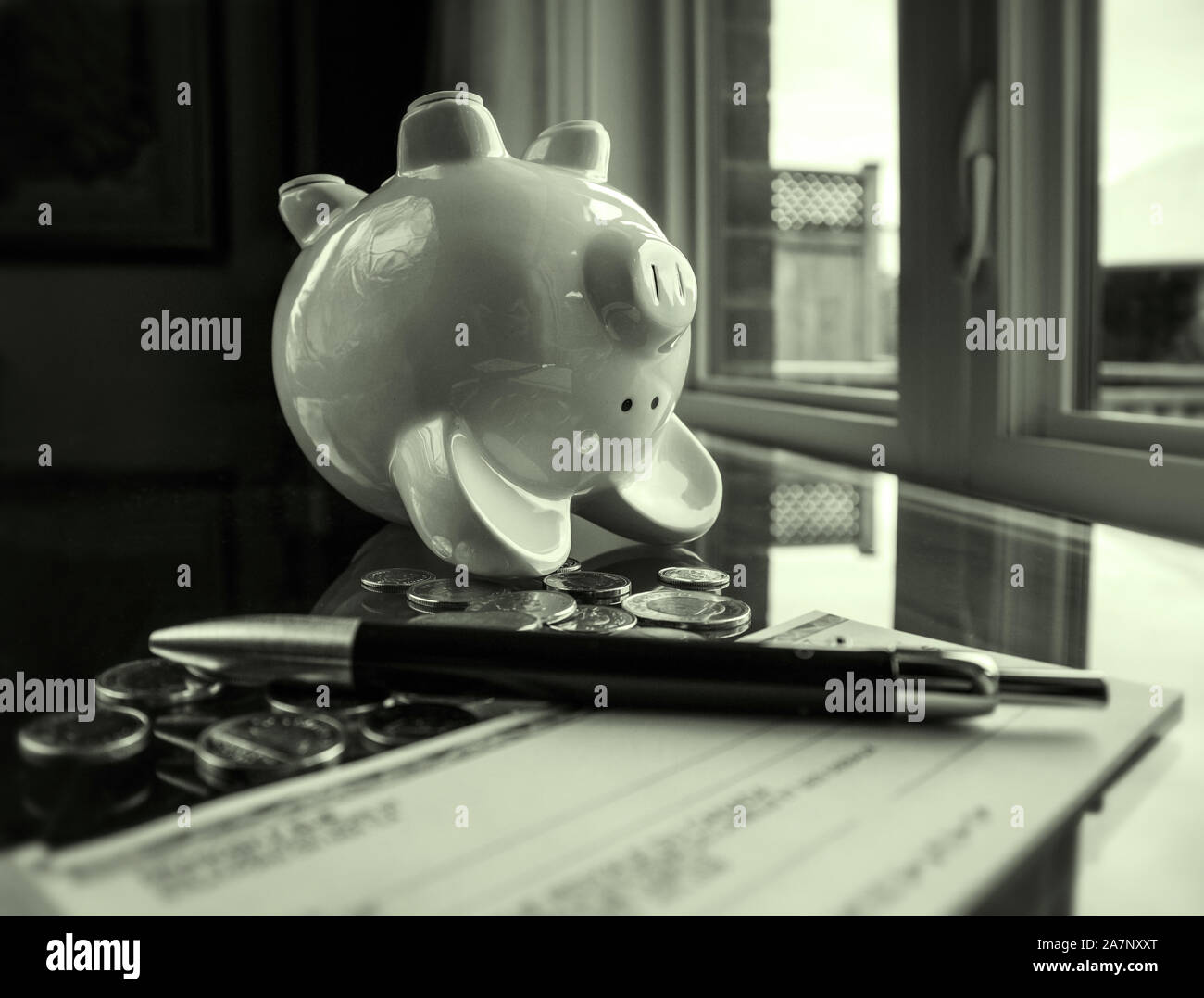 A piggy bank, upside down, after he 'emptied' of all his meager savings.. Stock Photo