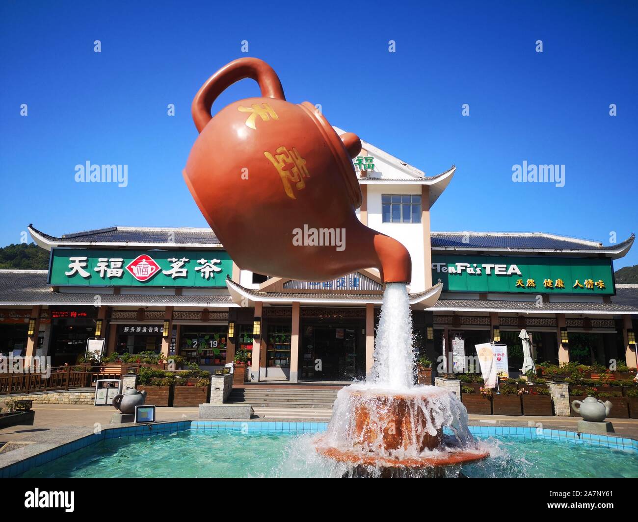 A giant floating teapot and teacup water fountain is displayed at an expressway service area in