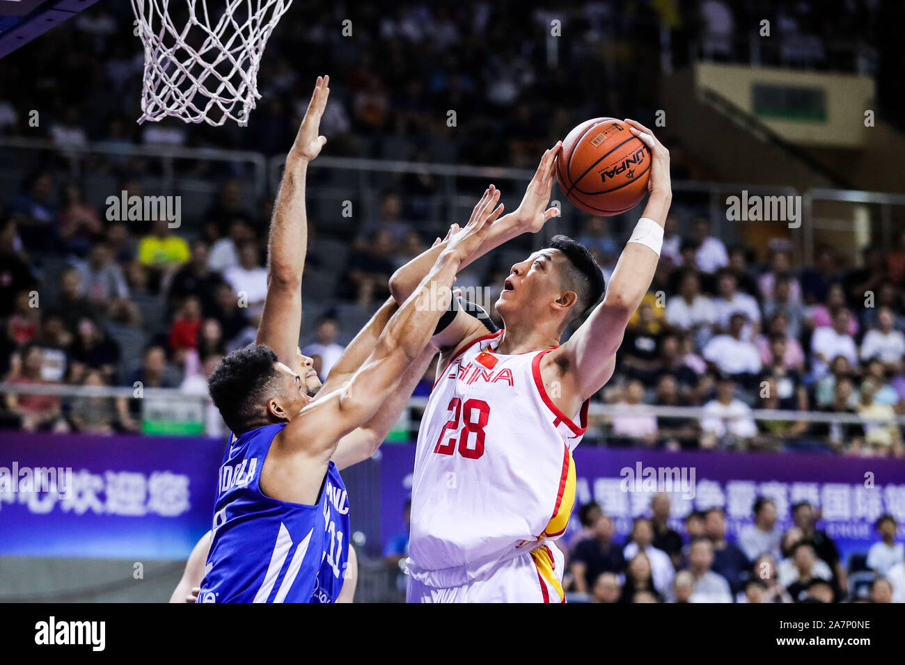 A member of China basketball team, right, is about to shoot during 2019