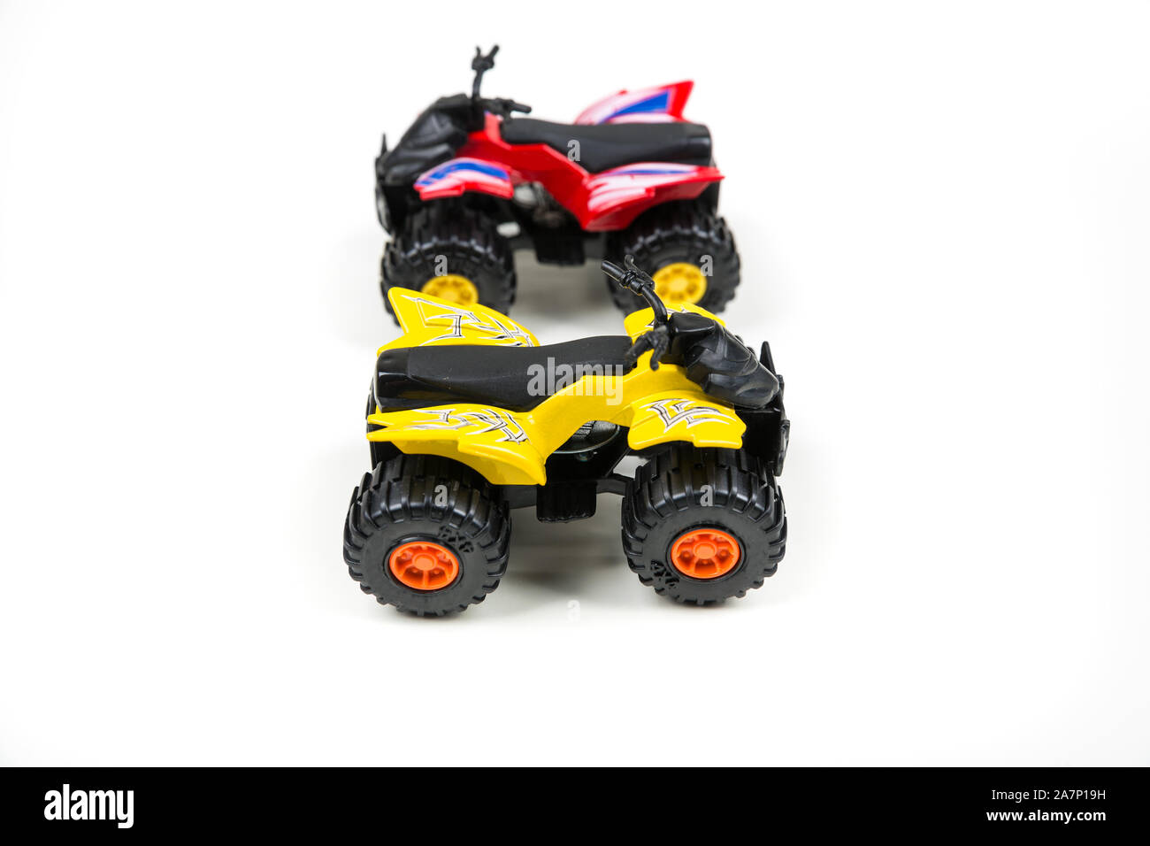 Red and yellow toy plastic quad atv on a white background Stock Photo