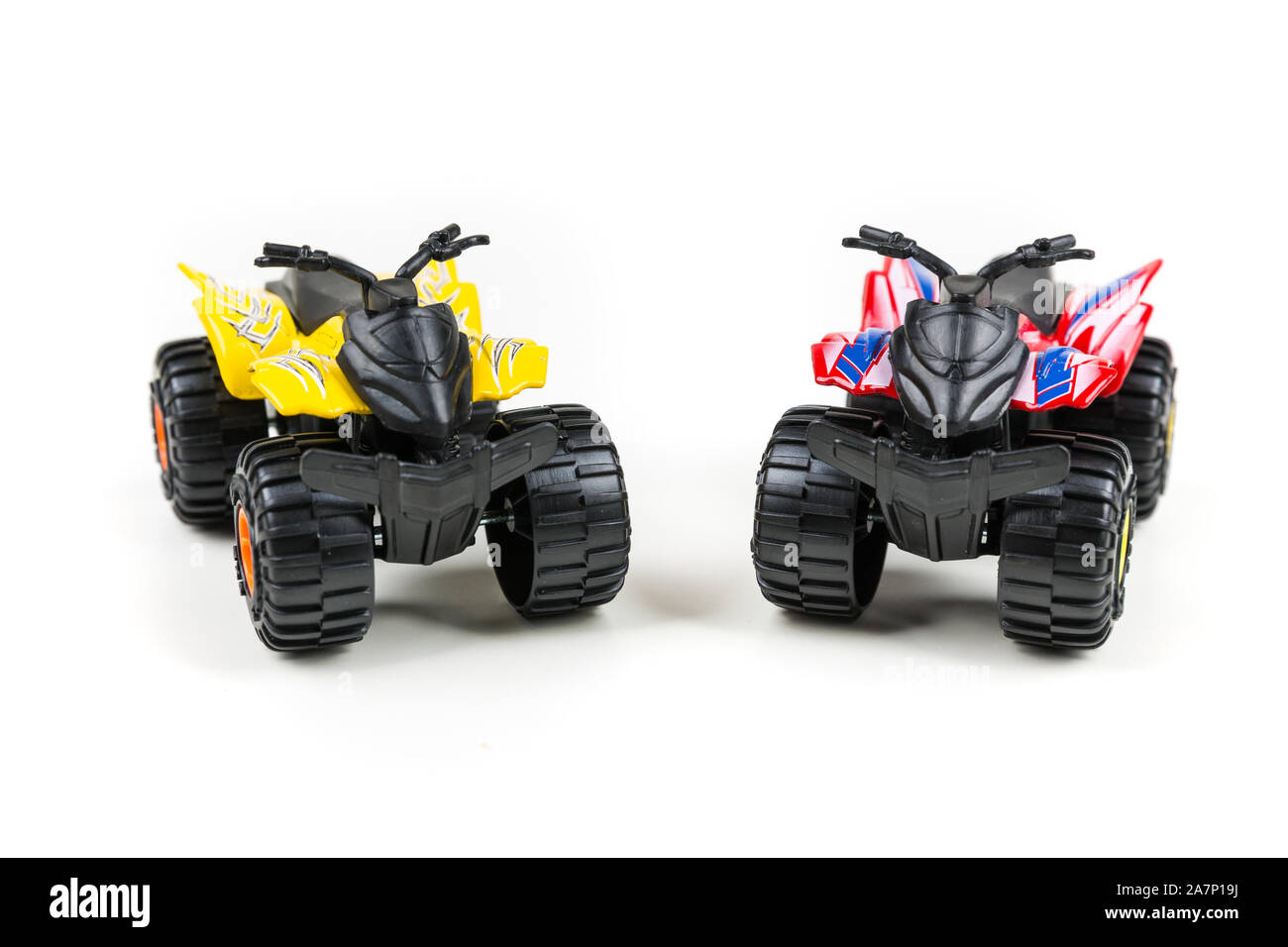 Red and yellow toy plastic quad atv on a white background Stock Photo