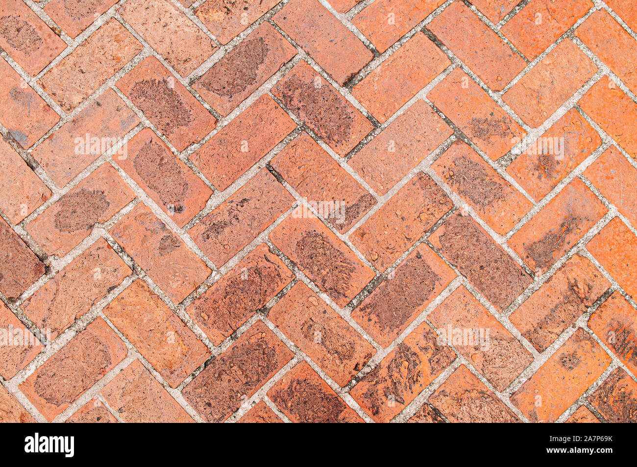Old red brick texture background, diagonal herringbone brick pattern retro grungy wallpaper Stock Photo