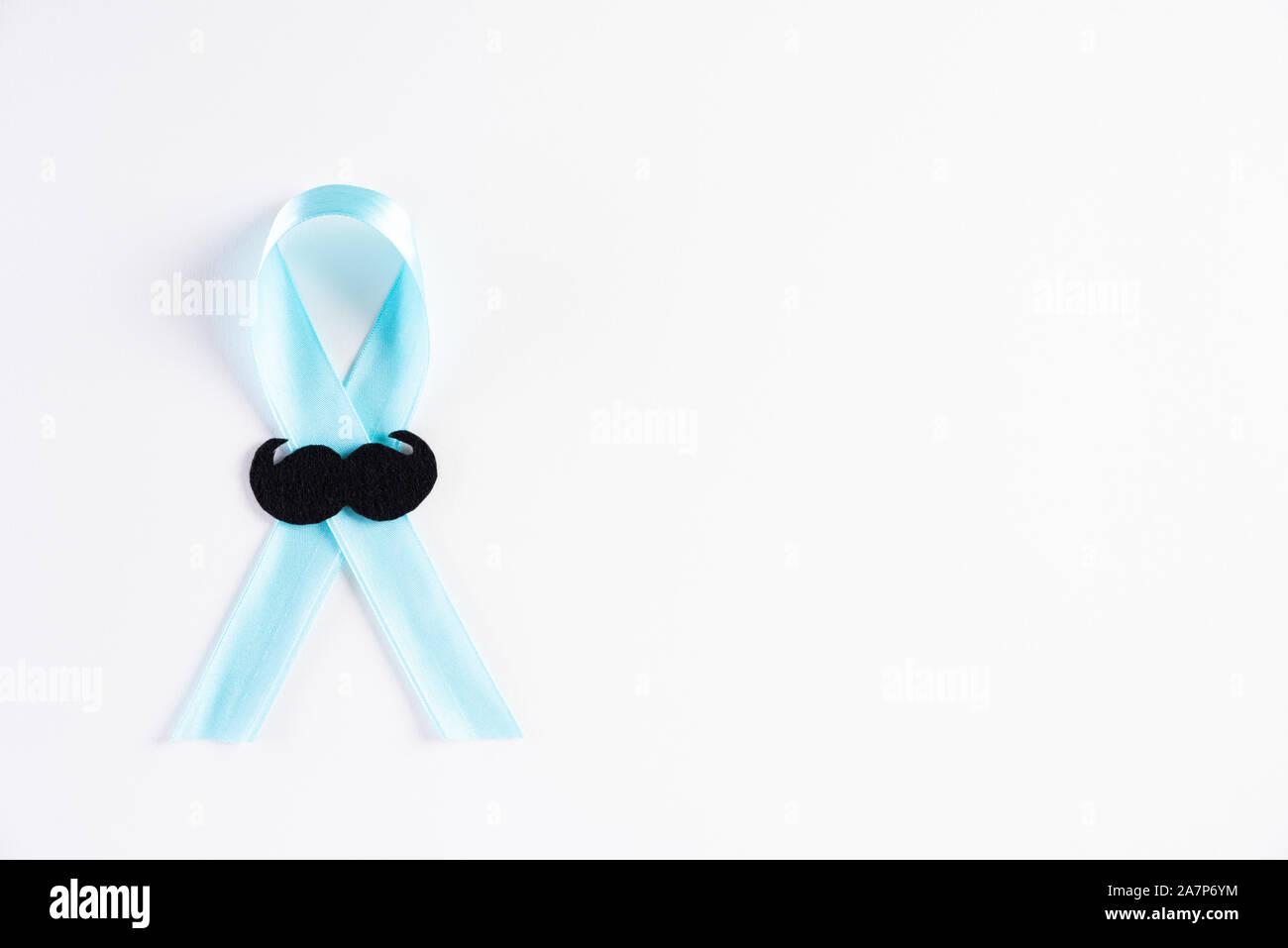 Blue ribbon with the growing of moustaches on white background representing an annual event during the month of November to raise awareness of men's h Stock Photo