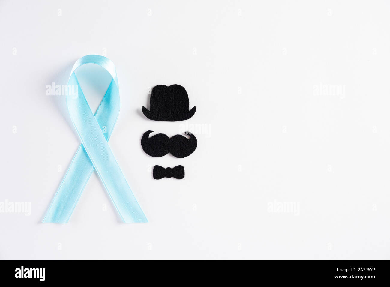 Blue ribbon with the growing of moustaches on white background representing an annual event during the month of November to raise awareness of men's h Stock Photo