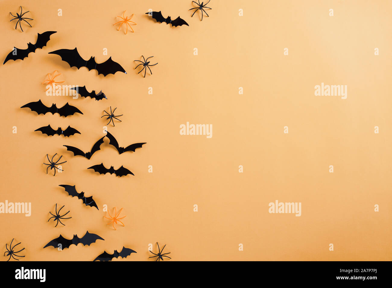 Top view of Halloween crafts, black paper ghost, spider and bats flying ...