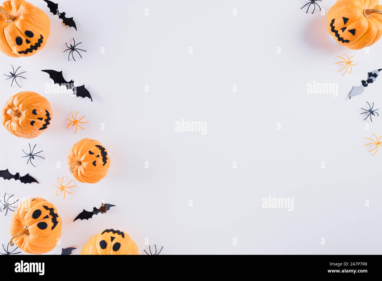 Top view of Halloween crafts, orange pumpkin, ghost, bat and spider on ...