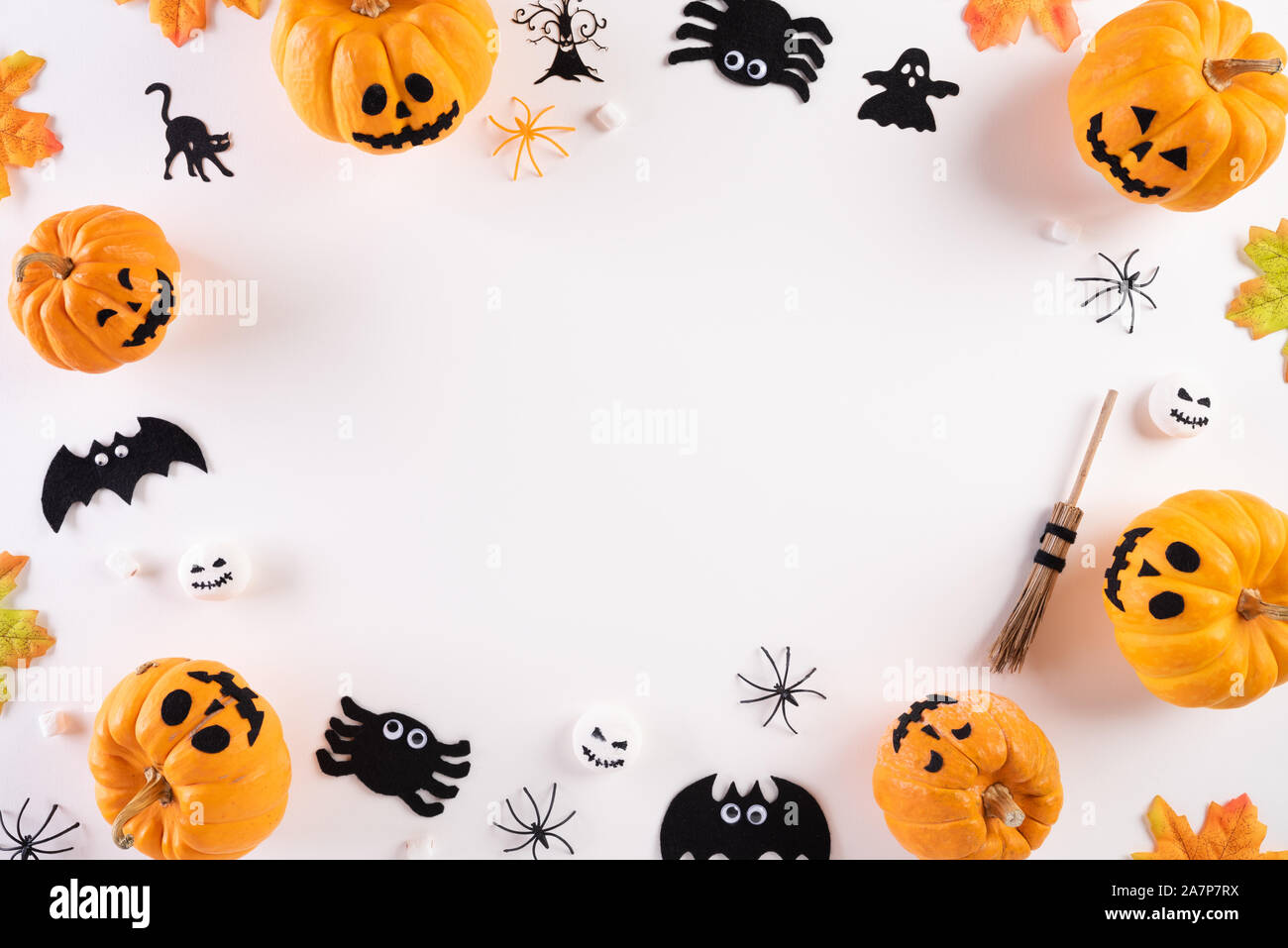 Top view of Halloween crafts, orange pumpkin, ghost, bat and spider on ...
