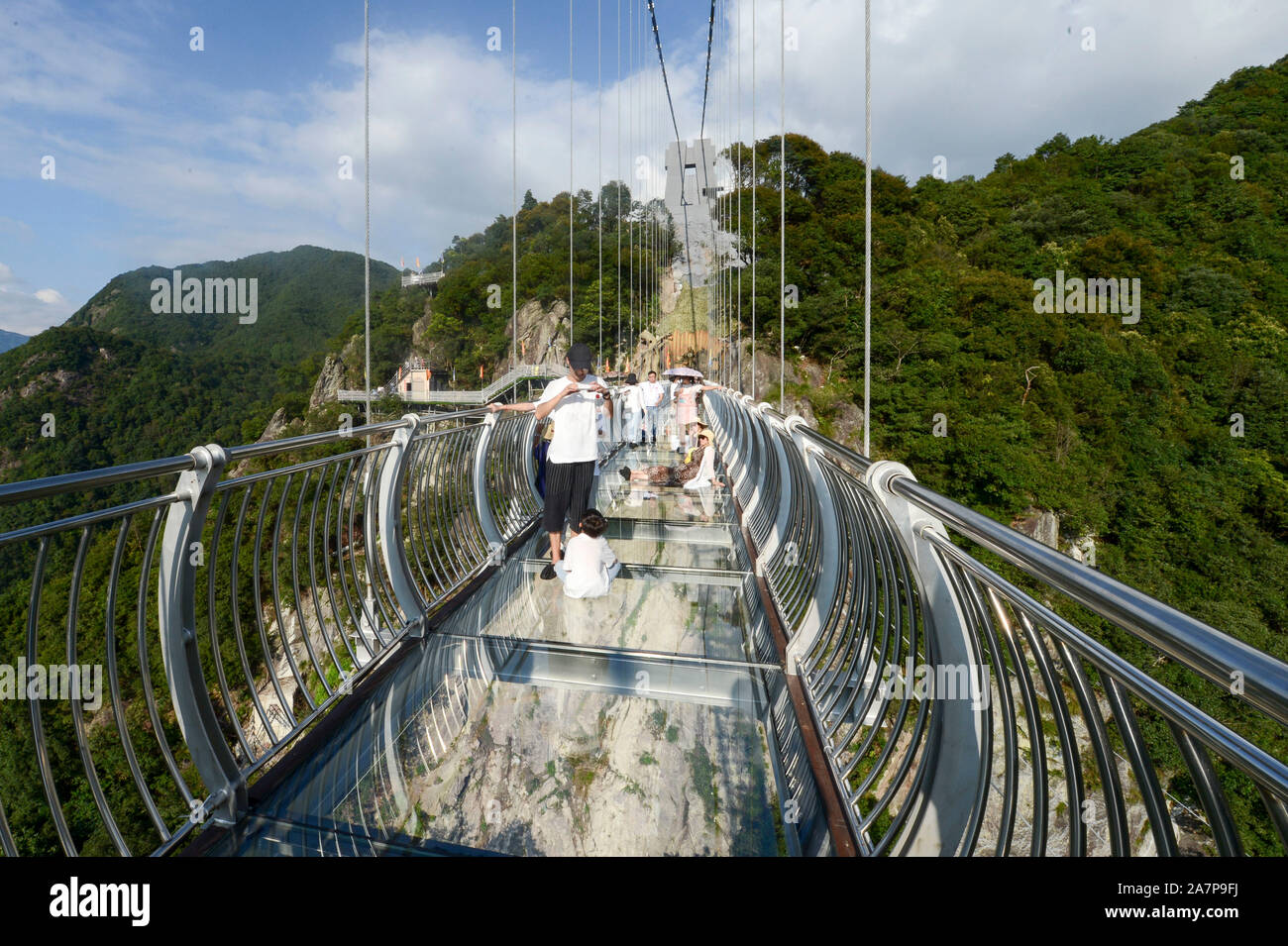 Visitors walk on the 419meterlong glassbottomed suspension bridge at