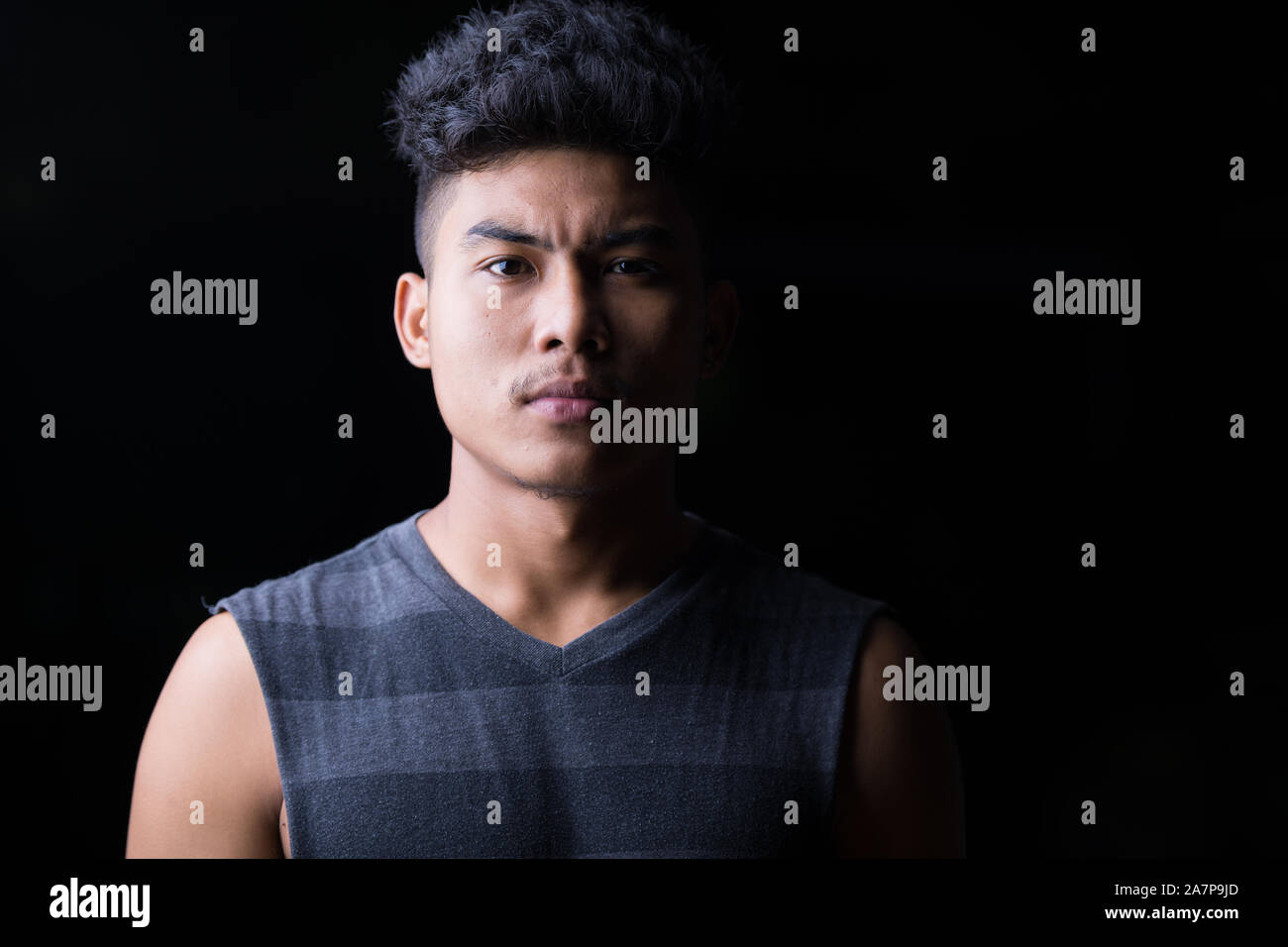 Face of young Asian man at night outdoors Stock Photo