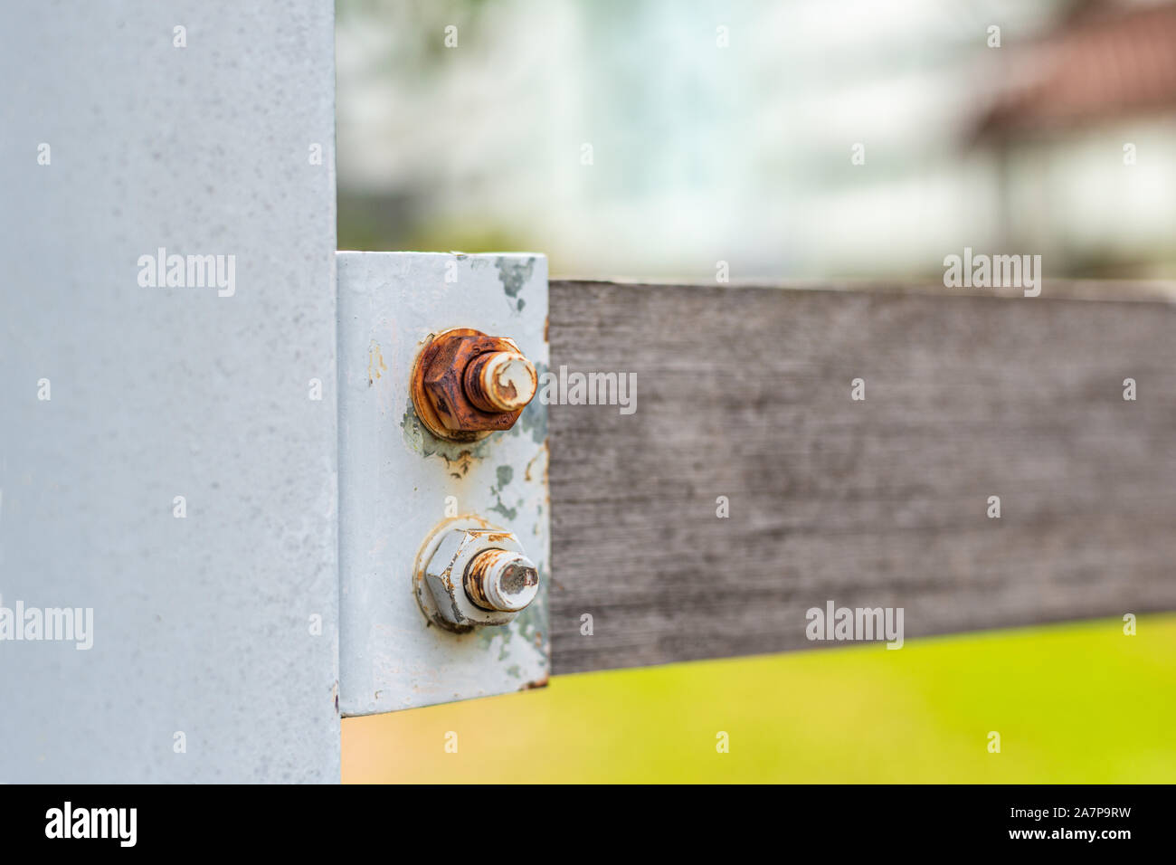 Rusty nuts and bolts on wood fence Stock Photo