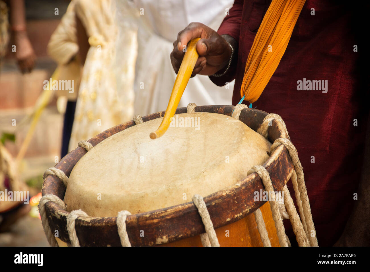 Close up of Hands performing Indian art form Chanda or chande cylindrical percussion drums playing during ceremony Stock Photo
