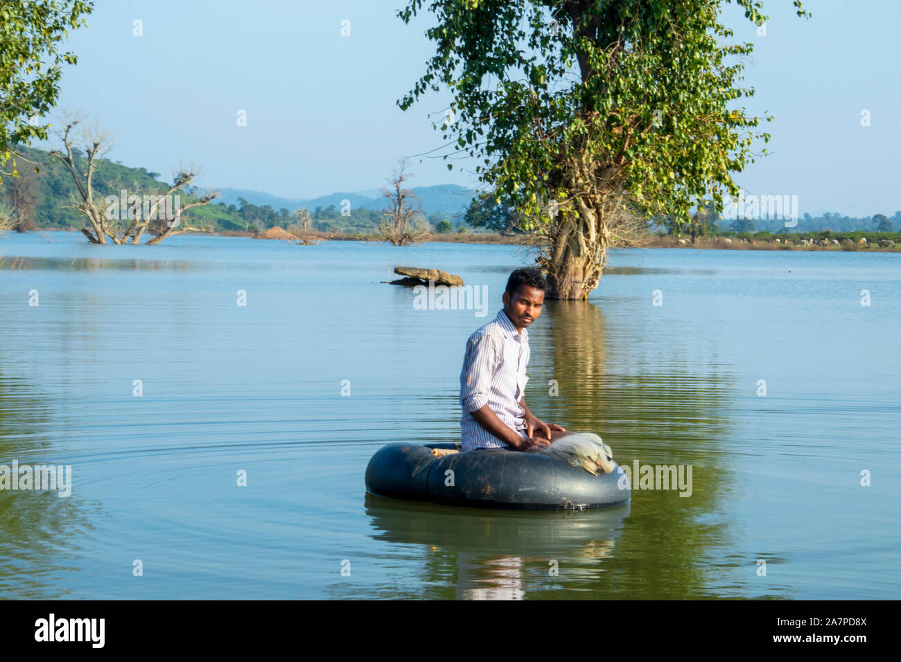 Scenic view of Lake.Young Fisherman Tubing at the  lake.HALON ,MADHYA PRADESH,INDIA-OCTOBER 31, 2019. Stock Photo