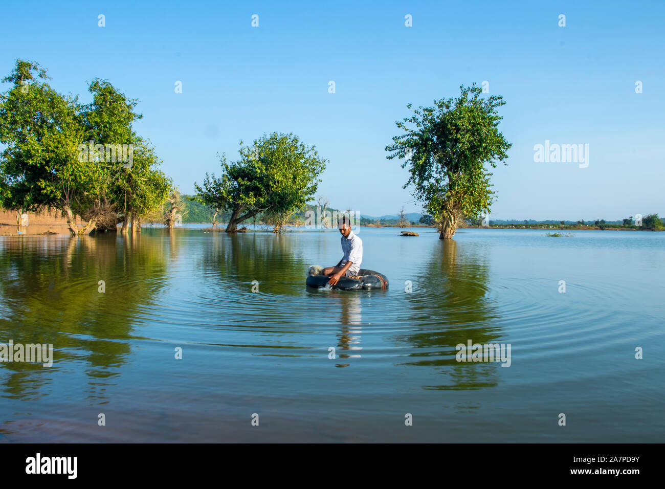 Scenic view of Lake.Young Fisherman Tubing at the  lake.HALON ,MADHYA PRADESH,INDIA-OCTOBER 31, 2019. Stock Photo