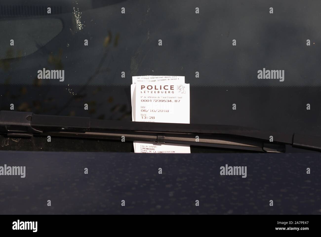 Parking violation ticket under windscreen wiper, Luxembourg, Stock Photo