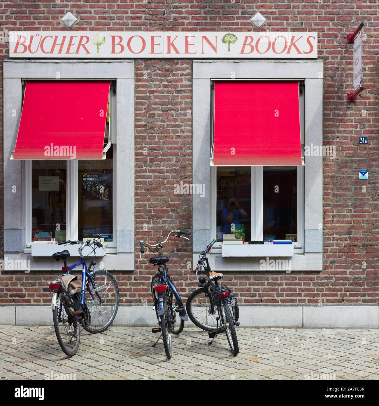 Three bicycles in front of book shop Stock Photo
