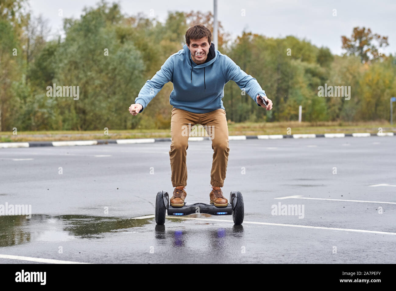Man riding on hoverboard and using smartphone outdoor Stock Photo Alamy