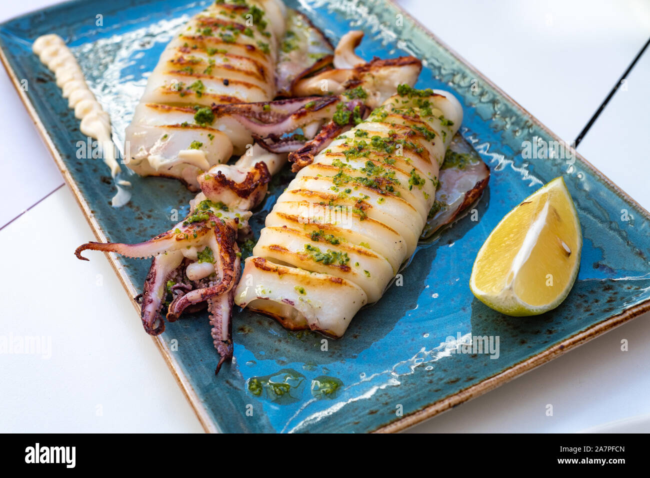 Delicious plate of grilled squid at gourmet restaurant Stock Photo