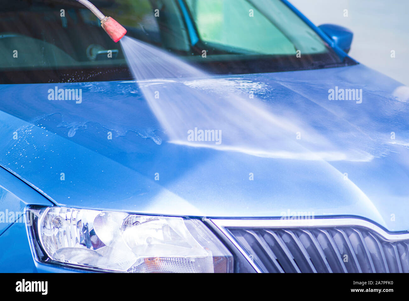 Manual car wash with pressurized water in car wash outside.Cleaning Car Using High Pressure