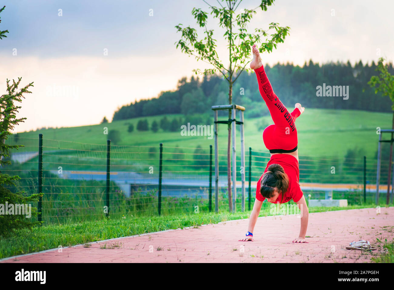 Girl acrobatics on the street.A girl does acrobatic stunts on the